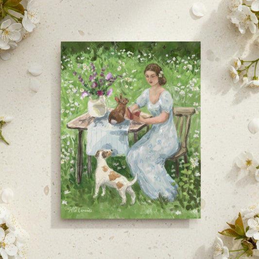 Greeting card of a woman reading a book with a rabbit and a terrier dog in a field of wildflowers, greeting card