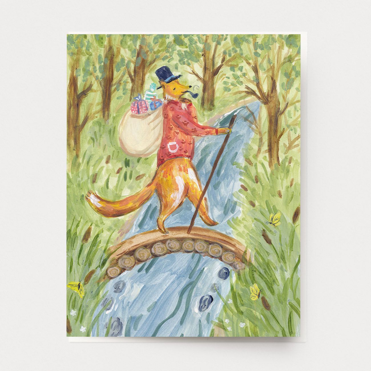 A birthday card of a gentleman fox, crossing a bridge in the forest with a sack of brightly wrapped gifts. Hand illustrated by artist Katherine Lewis. Made by Ingrid Press card and gift company, ethically printed in the USA.