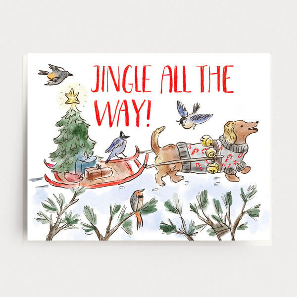 Illustration of a dachshund dog pulling a sled with a Christmas tree and presents, with 'Jingle All the Way!' text above.