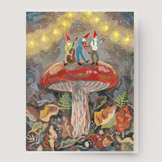 Artistic greeting card of three gnomes on a large mushroom with a starry night sky background.