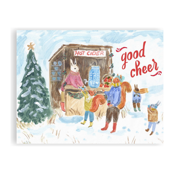 A holiday card with woodland animals getting hot cider from a festive stall and the words, Good Cheer. Ingrid Press, made in the USA