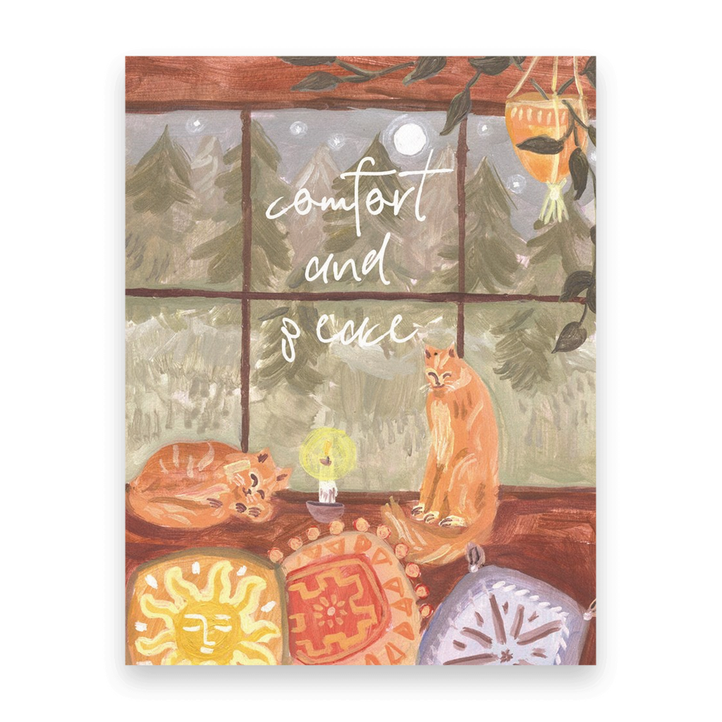 Postcards of two cats on a windowsill with colorful cushions and a nighttime forest outside, with the words, comfort and peace. Ingrid Press, made in the USA.
