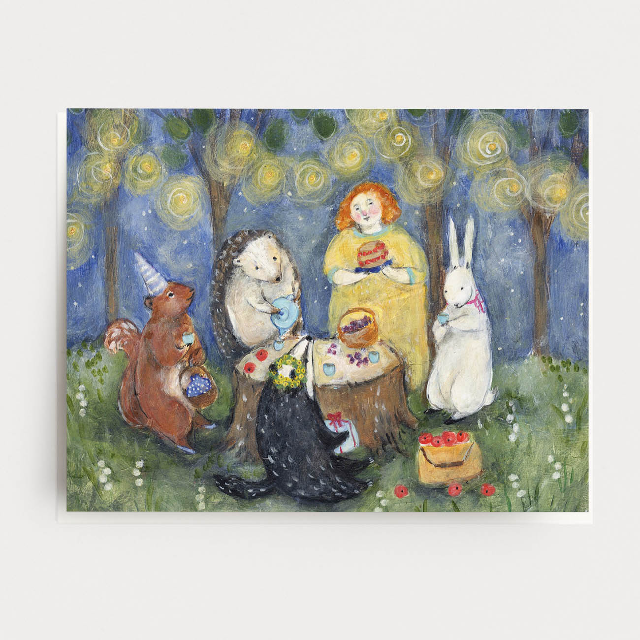 Greeting card of a girl and her animal friends having a birthday tea party on a stump, surrounded by a blue starry sky and lights hanging in the trees.  Hand illustrated by artist Katherine Lewis. Made by Ingrid Press card and gift company, ethically printed in the USA.