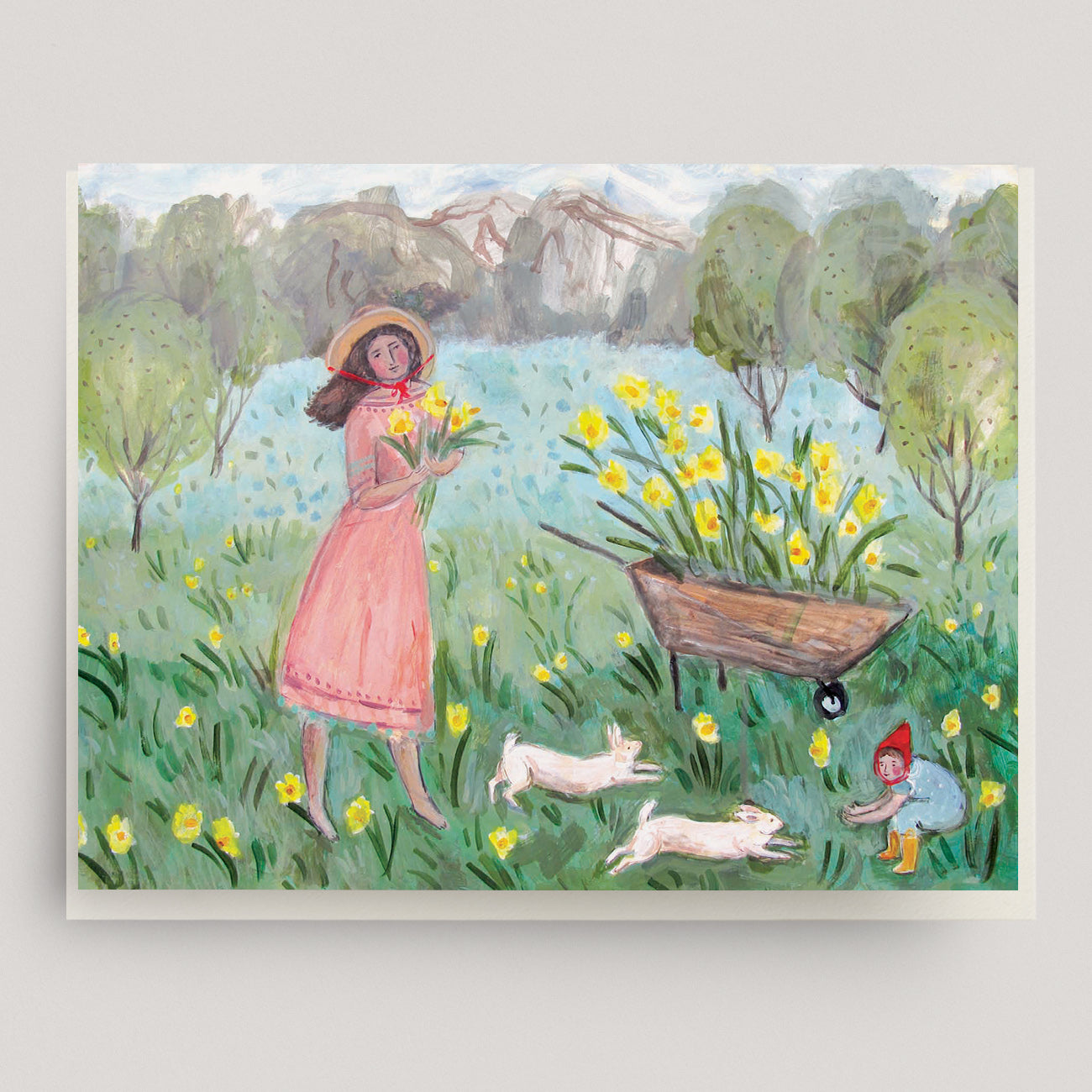 Greeting card of a woman and her child in a field of flowers with mountains in the background. Ingrid Press, made in the USA.