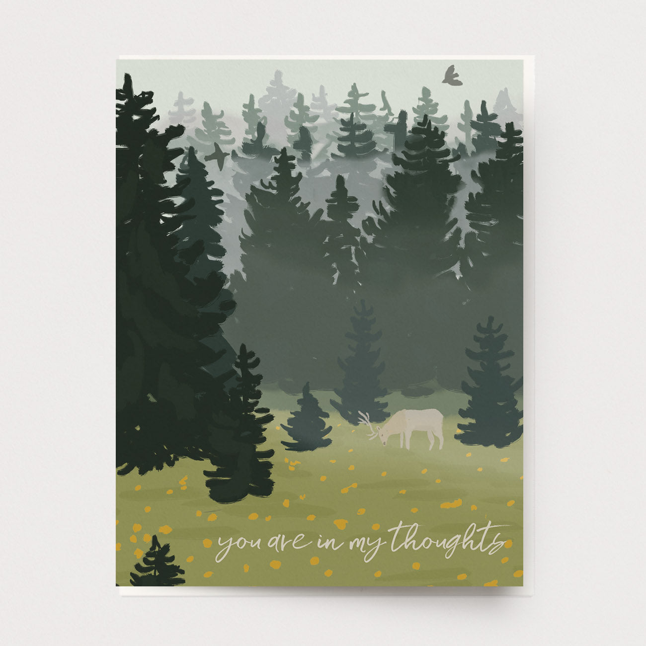 Sympathy greeting card of an elk standing in a field of flowers with a backdrop of foggy dark trees. The text says, You are in my thoughts. Made by Ingrid Press, printed in the USA